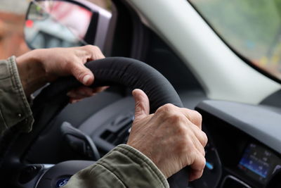 Midsection of man driving car