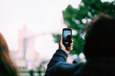 Young woman photographing through smart phone