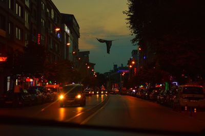 Illuminated city street at night