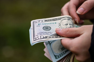 Close-up of hand holding paper