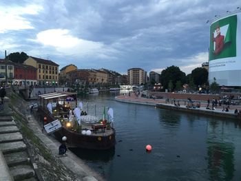 Boats in river with buildings in background