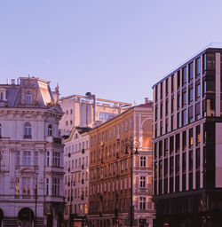 Low angle view of buildings against clear blue sky