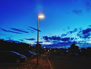 Cars on illuminated street at dusk