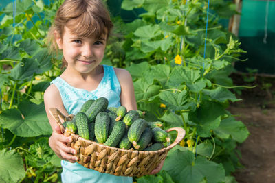 Portrait of woman holding plant