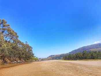 Scenic view of road against clear blue sky