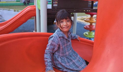 Portrait of smiling girl standing outdoors