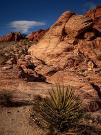 Rock formation on landscape against sky