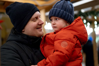 Father with daughter wearing warm clothing