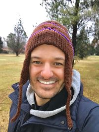 Portrait of smiling young man in park during winter