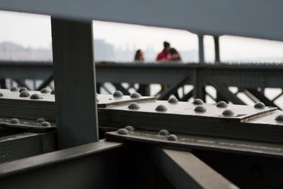 Close-up of people by railing