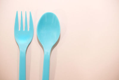 Close-up of blue paint on table against white background