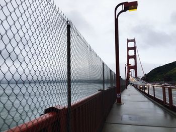 Footbridge against sky in city