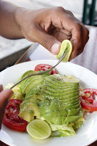 Midsection of man preparing food in plate