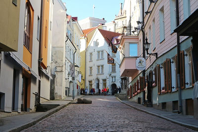 Narrow street amidst buildings in city