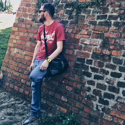 Young man standing on wall