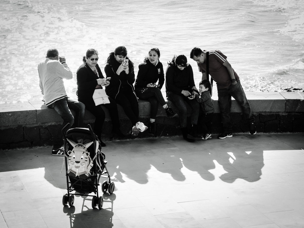 group of people, water, real people, men, lifestyles, sea, leisure activity, nature, women, people, full length, day, togetherness, adult, sunlight, group, friendship, standing, shadow, outdoors, swimming pool