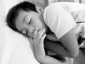 Close-up of woman sleeping on bed at home