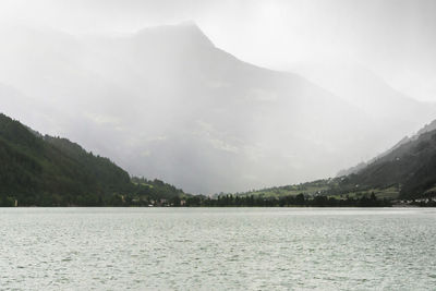 Scenic view of sea and mountains against sky