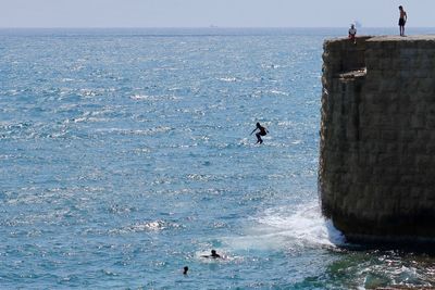 Man jumping off cliff