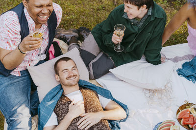 High angle view of friends from lgbtq community having fun during dinner party in back yard