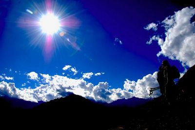 Scenic view of silhouette mountains against blue sky