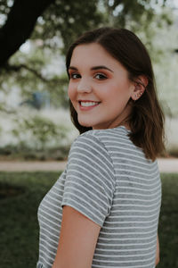 Portrait of smiling young woman standing outdoors