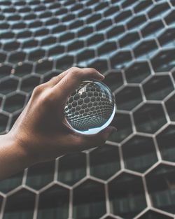 Close-up of hand holding crystal ball 