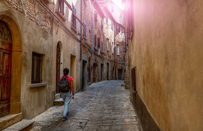 Volterra,tuscany, italy. amazing shot of a charming alley in the historic center.  middle-aged woman