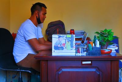 Man sitting on table at home