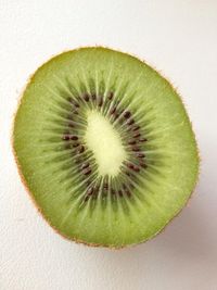 Directly above shot of fruit slices on white background