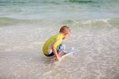 Boy playing at sea shore