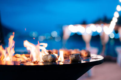 Close-up of burning candles on table