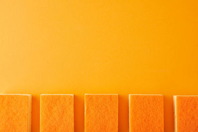 Close-up of books against yellow background