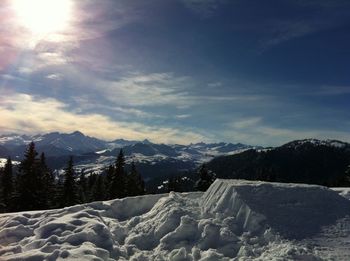 Scenic view of snow covered mountains against sky