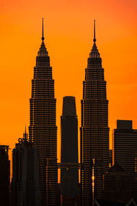 Silhouette buildings against sky during sunset