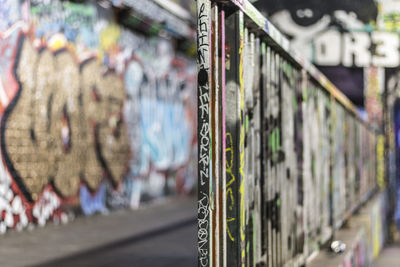 Close-up of graffiti on railing at tunnel