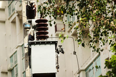 Low angle view of electric lamp on building