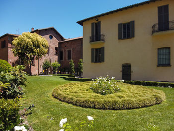 Lawn by building against sky