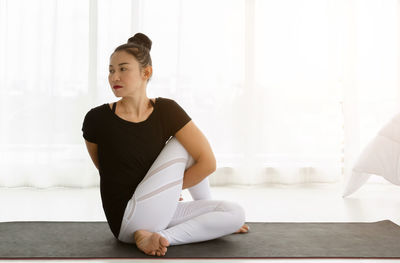 Young woman sitting on floor