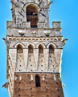 Low angle view of bell tower against blue sky