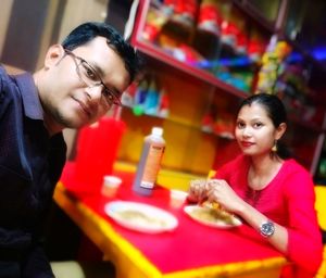 Portrait of smiling young man sitting at restaurant