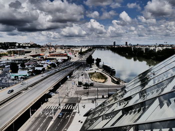 High angle view of bridge over river in city against sky