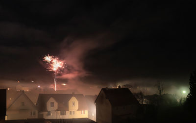 Low angle view of firework display at night