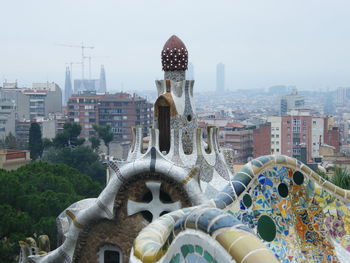 Low angle view of statue against buildings in city