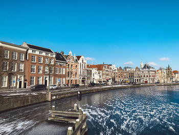 View of buildings in city against blue sky