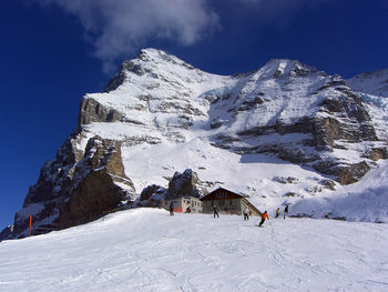 People skiing on snow covered mountain