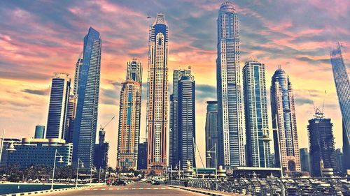 Modern buildings against cloudy sky