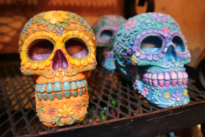 Close-up of colorful human skulls on table