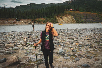 Portrait of smiling woman standing on land