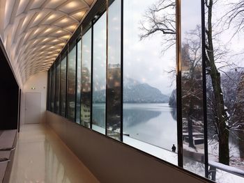 Scenic view of snow covered mountains seen through window